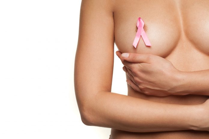 Naked woman wearing a pink breast cancer ribbon